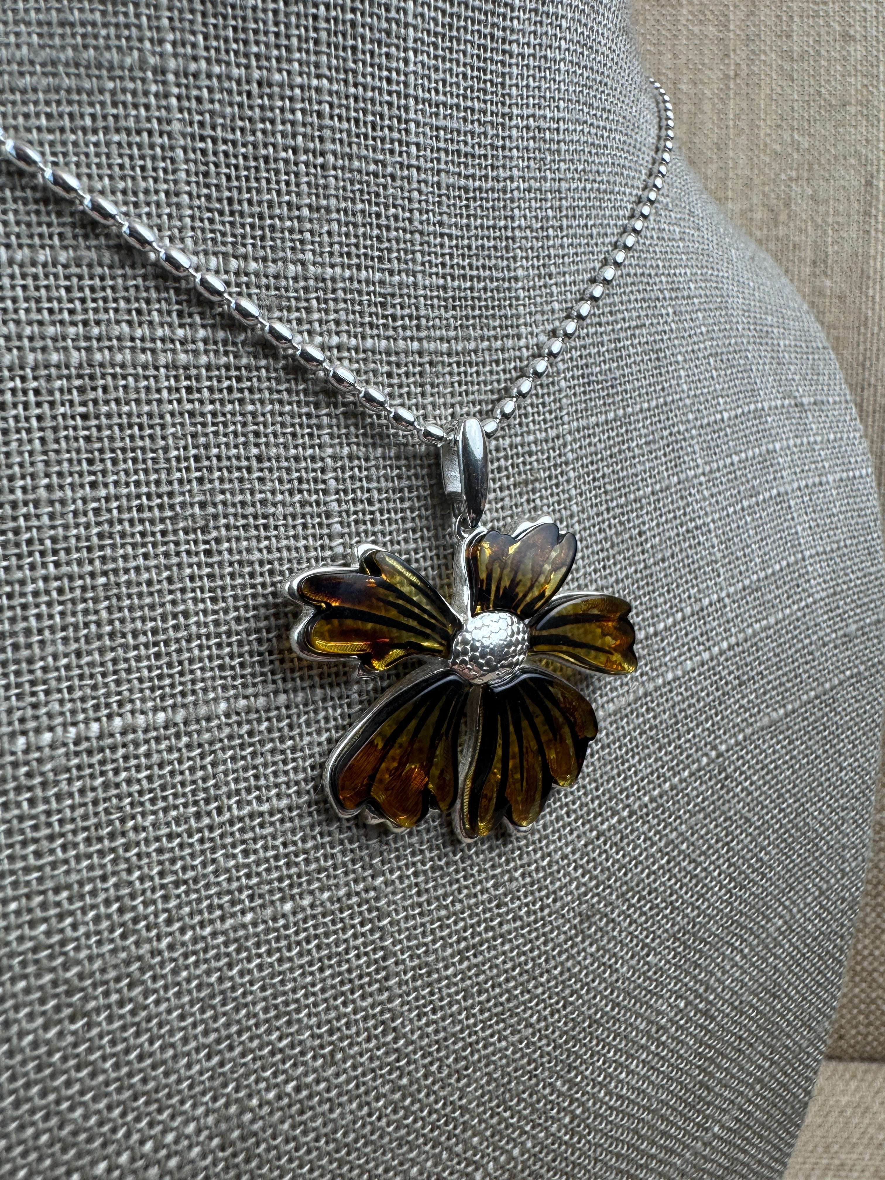 A bloom unlike any other—this one-of-a-kind flower pendant is crafted from genuine Baltic Amber and set in sterling silver.