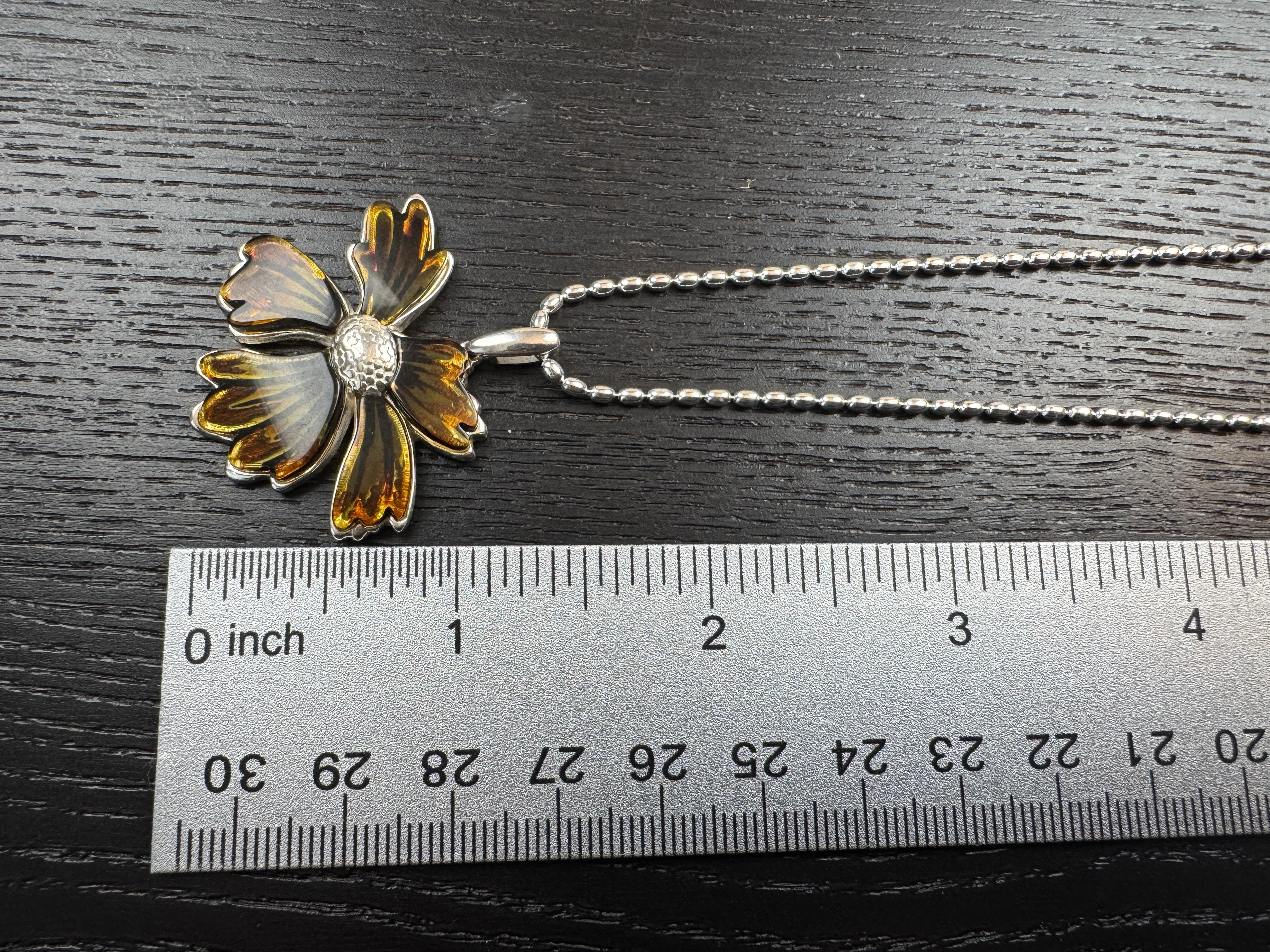 A bloom unlike any other—this one-of-a-kind flower pendant is crafted from genuine Baltic Amber and set in sterling silver.