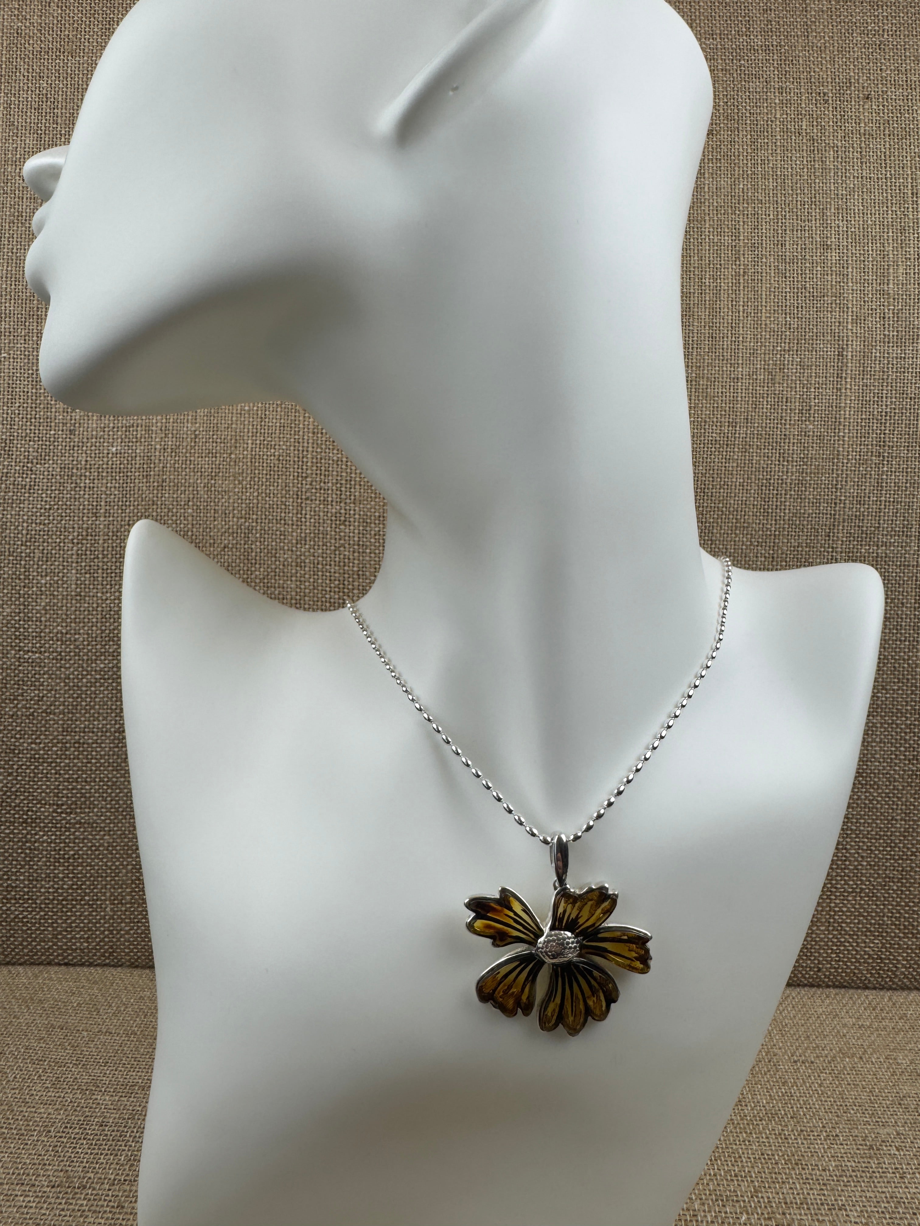 A bloom unlike any other—this one-of-a-kind flower pendant is crafted from genuine Baltic Amber and set in sterling silver.