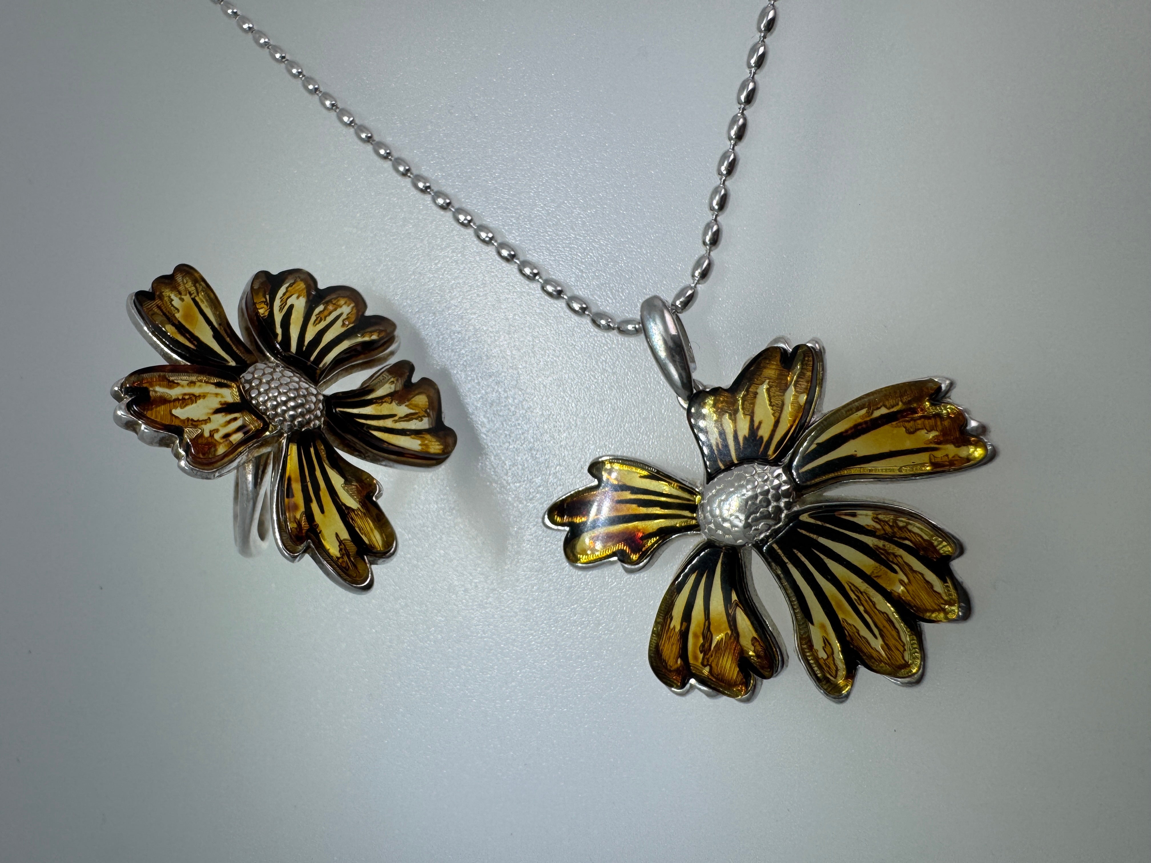 A bloom unlike any other—this one-of-a-kind flower pendant is crafted from genuine Baltic Amber and set in sterling silver.