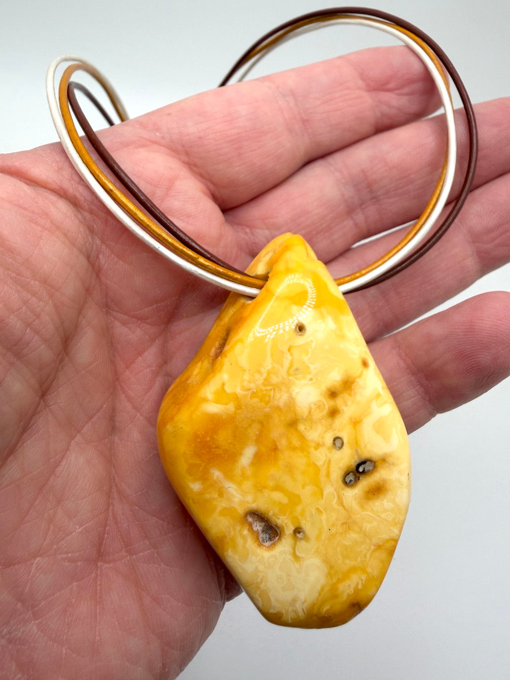 One of a kind Butterscotch Amber necklace on multi leather with silver clasp
