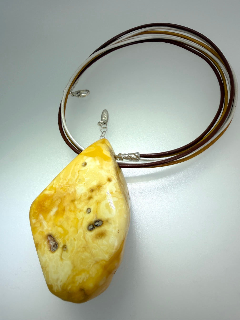 One of a kind Butterscotch Amber necklace on multi leather with silver clasp