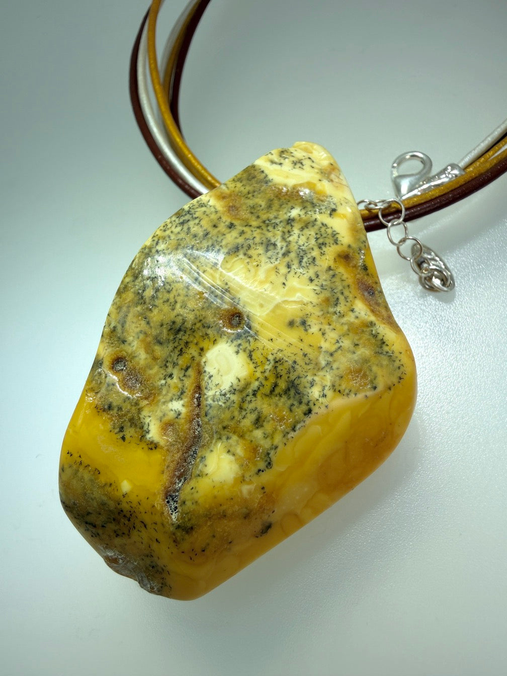 One of a kind Butterscotch Amber necklace on multi leather with silver clasp