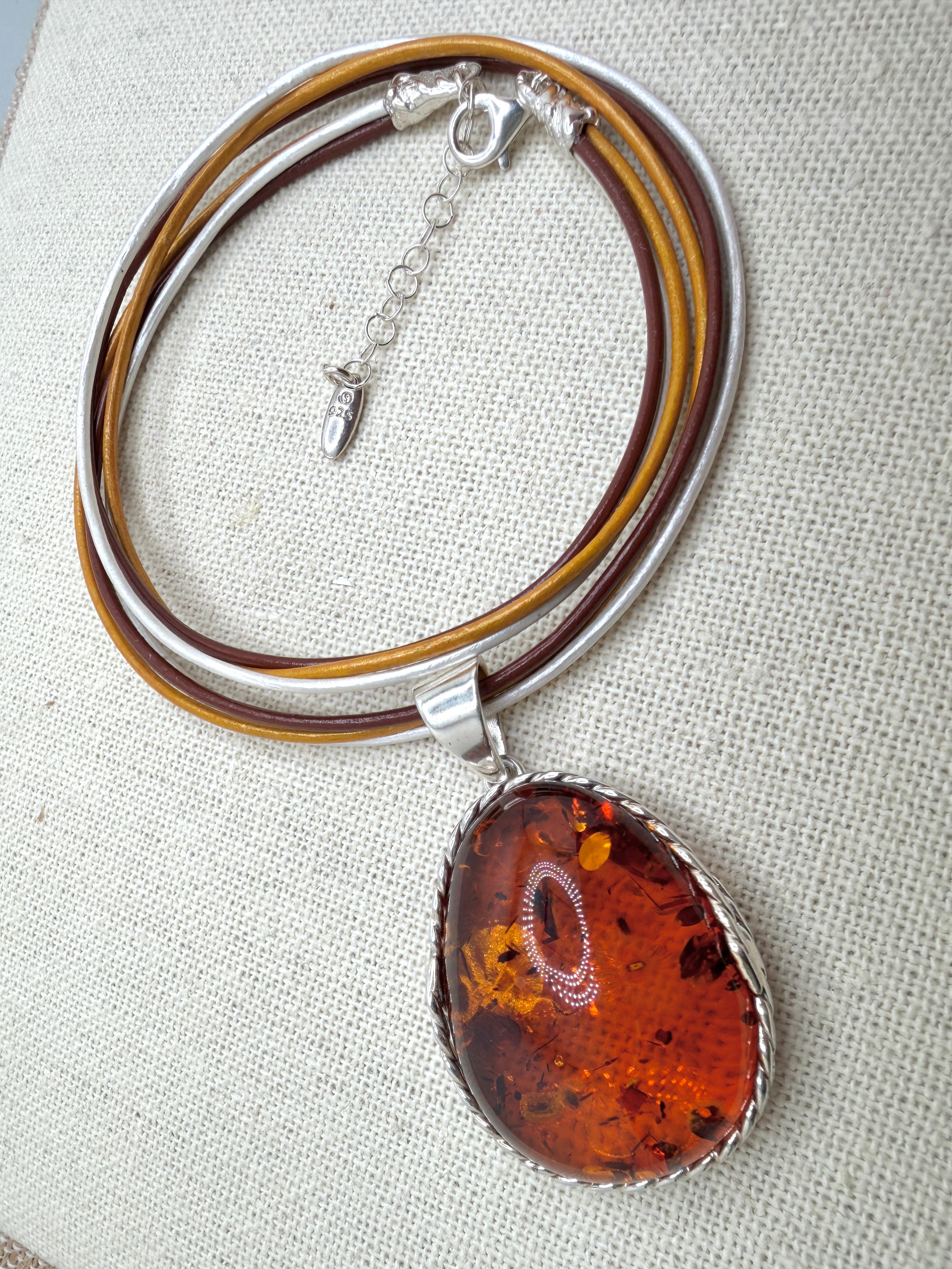 Oversized Honey Cognac Baltic Amber Pendant on Thick Brown, Gold and White Leather Cord – Handmade in Poland – Sterling Silver Setting