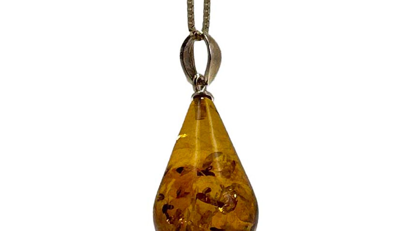 A teardrop-shaped amber pendant with inclusions on a silver chain.