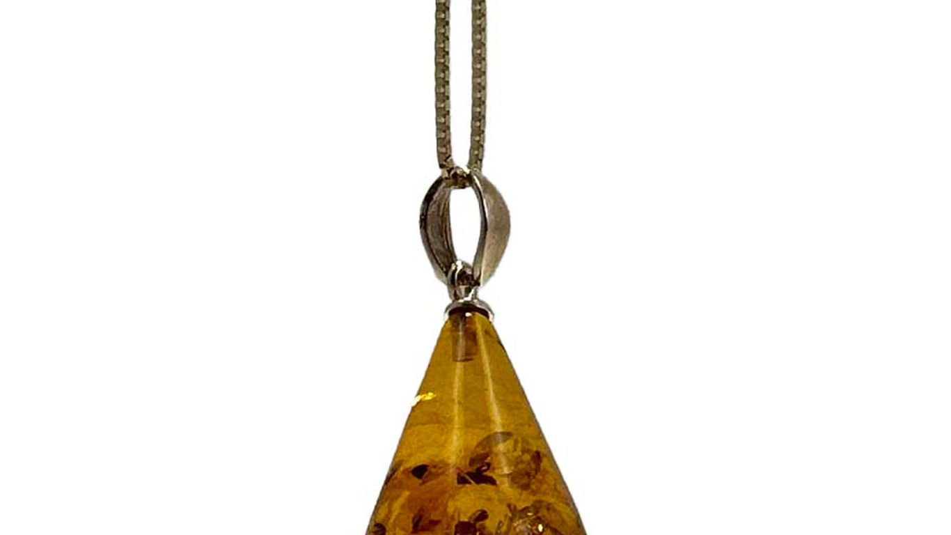 A teardrop-shaped amber pendant with inclusions on a silver chain.