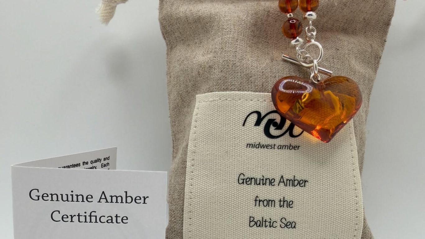 Amber necklace with heart pendant, pouch, and certificate.