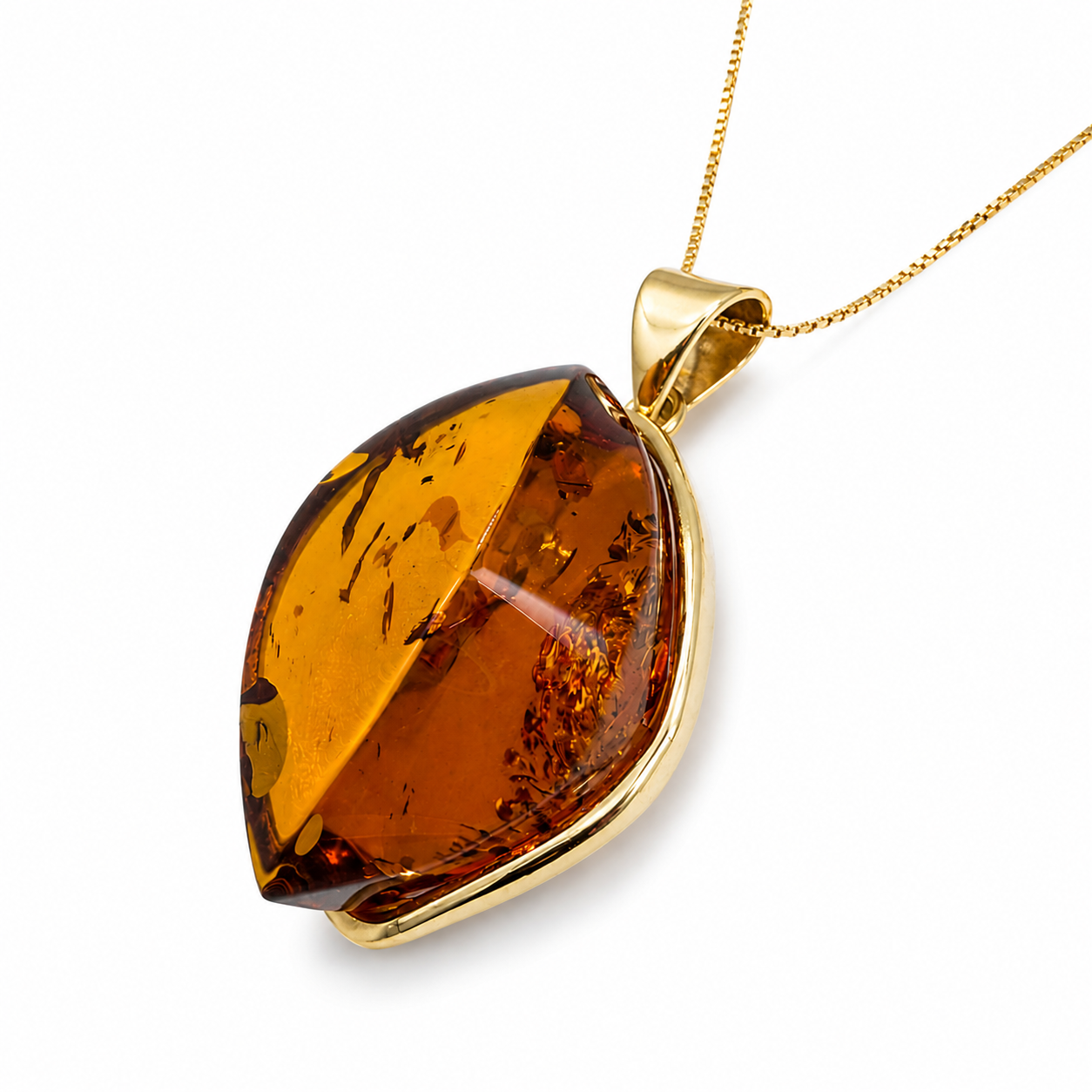 A gold pendant necklace featuring a large, teardrop-shaped amber gemstone with natural inclusions, suspended from a delicate gold chain against a clean white background.