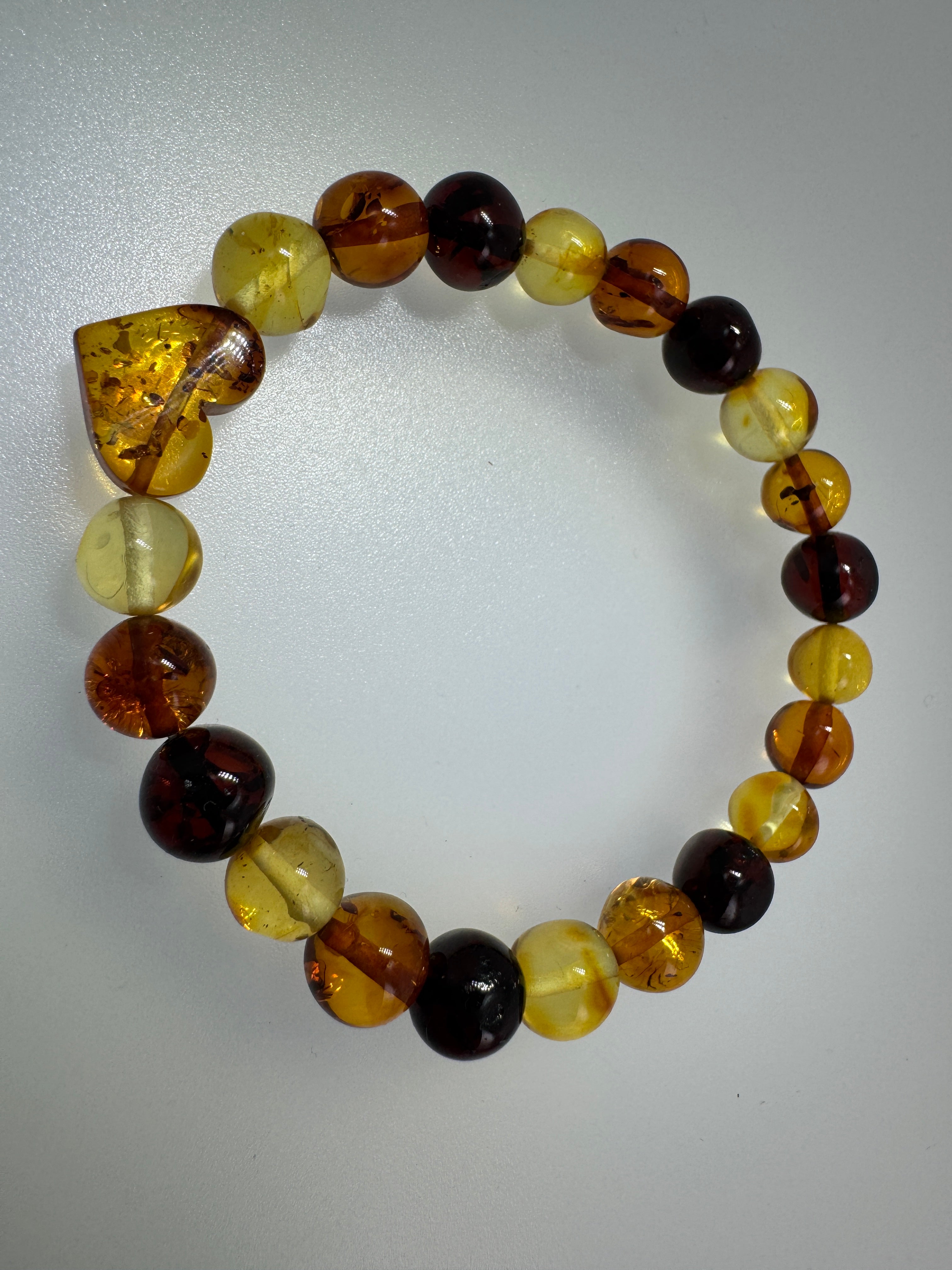 Multicolor Baltic Amber Stretch Bracelet with Hand-Carved Heart Charm – One Size Comfort Fit