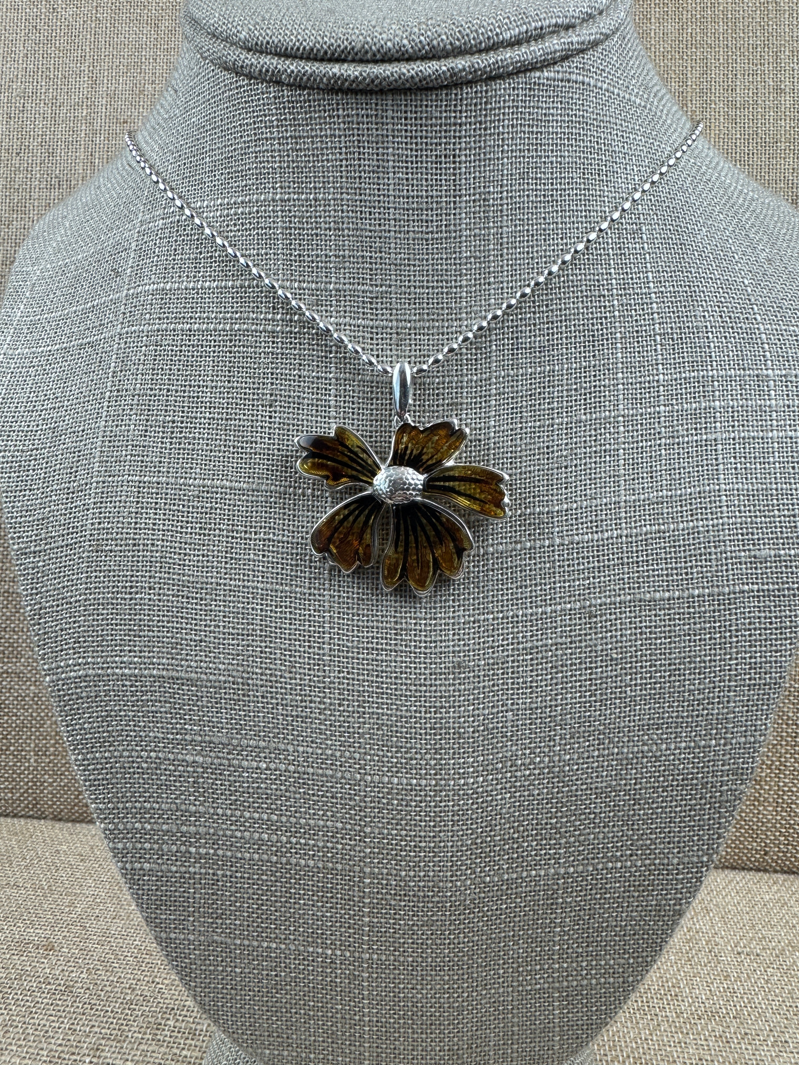 A bloom unlike any other—this one-of-a-kind flower pendant is crafted from genuine Baltic Amber and set in sterling silver.