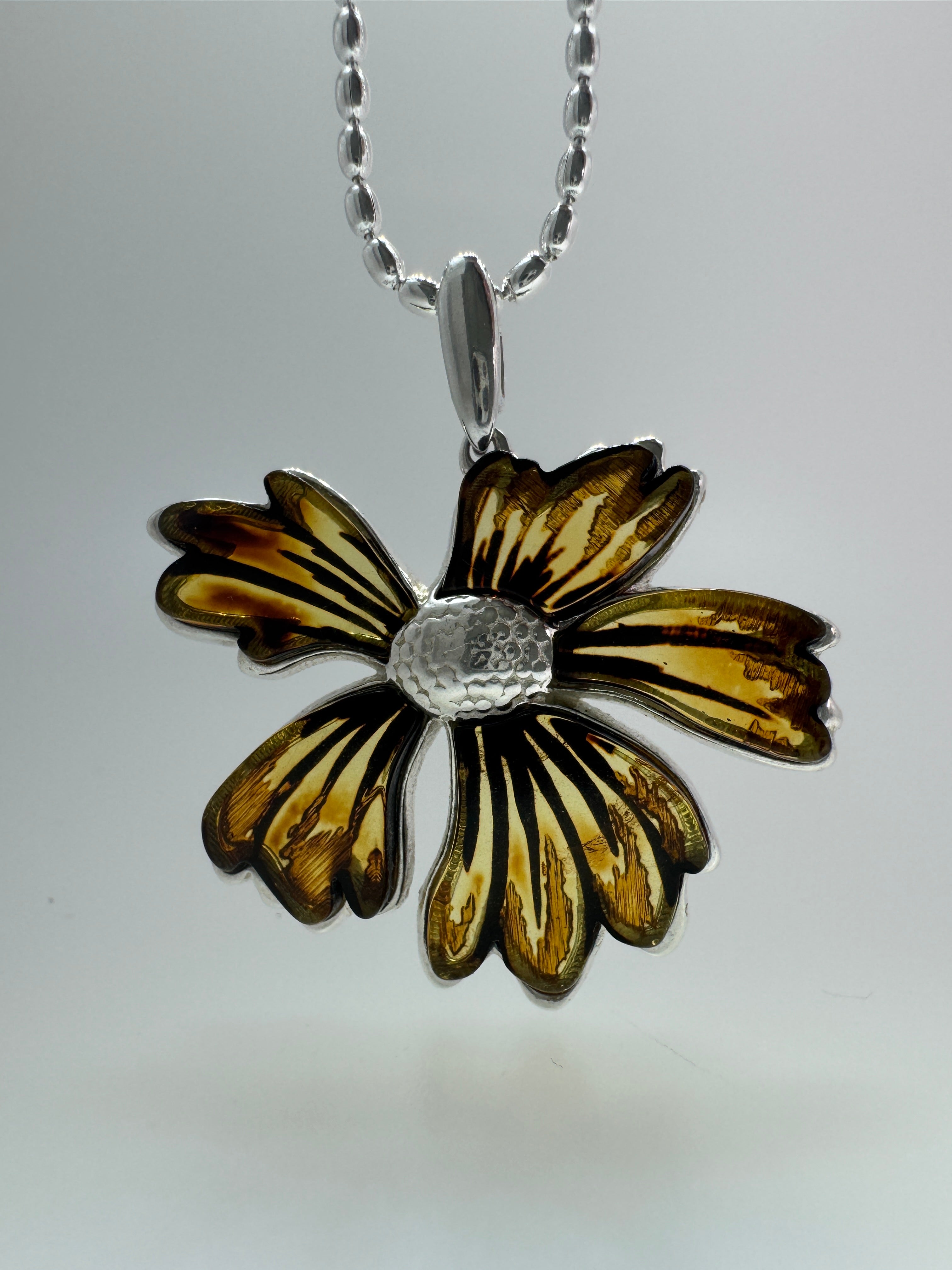 A bloom unlike any other—this one-of-a-kind flower pendant is crafted from genuine Baltic Amber and set in sterling silver.
