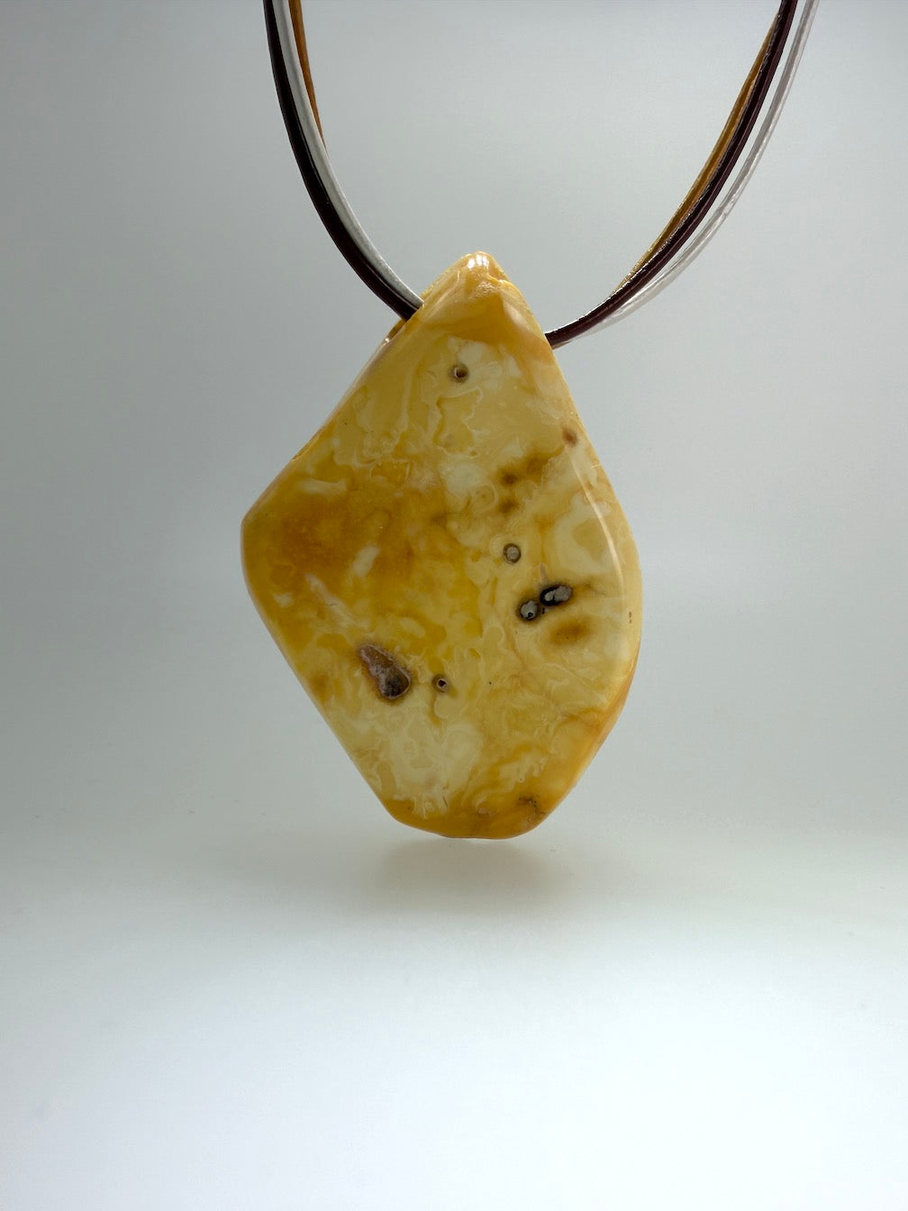 One of a kind Butterscotch Amber necklace on multi leather with silver clasp
