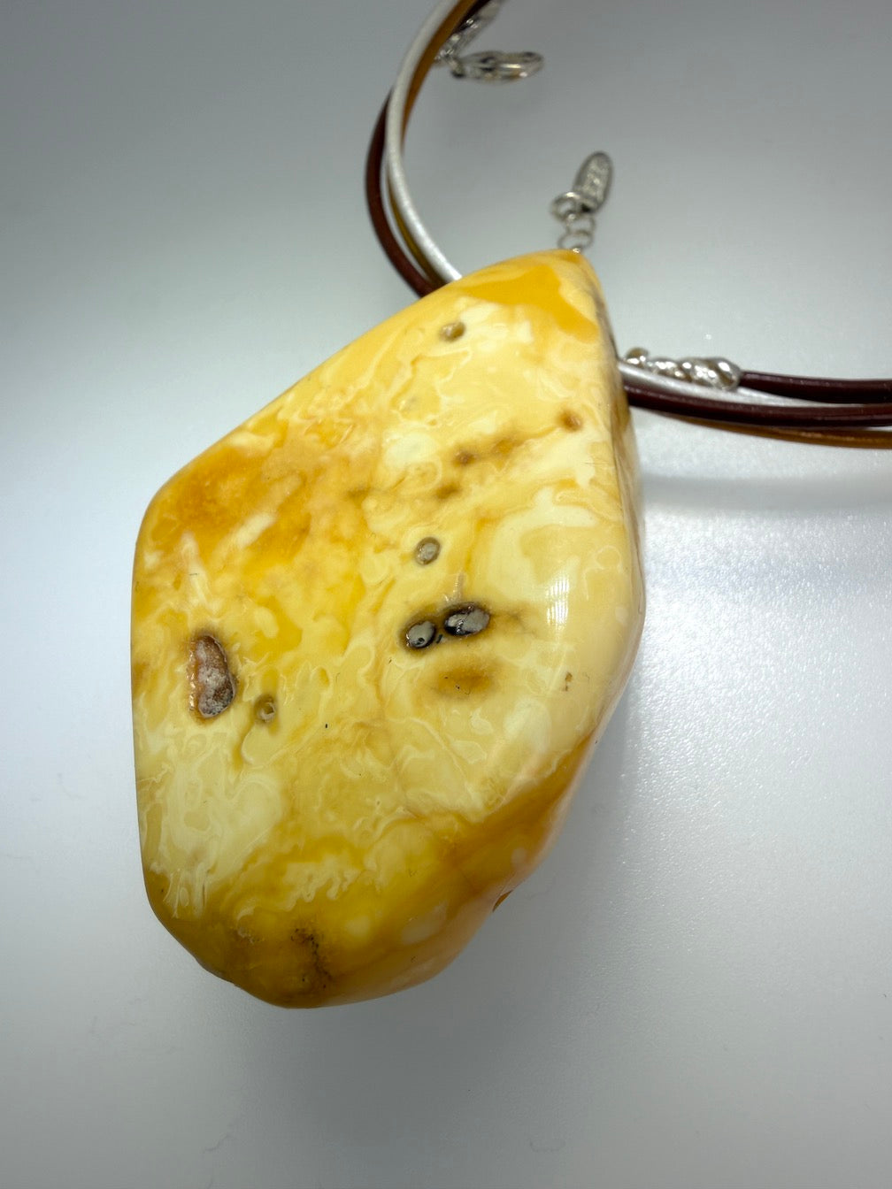 One of a kind Butterscotch Amber necklace on multi leather with silver clasp