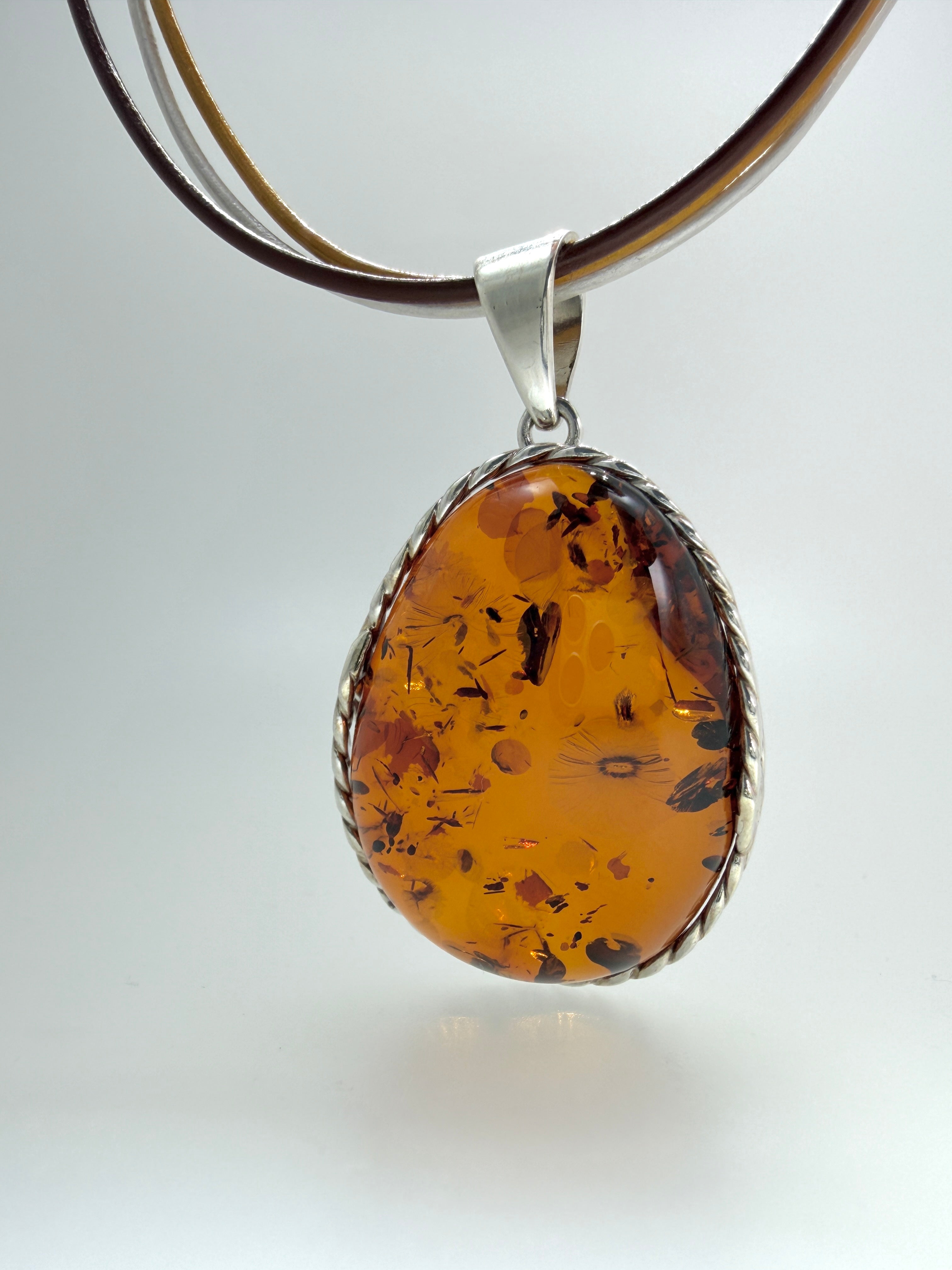 Oversized Honey Cognac Baltic Amber Pendant on Thick Brown, Gold and White Leather Cord – Handmade in Poland – Sterling Silver Setting