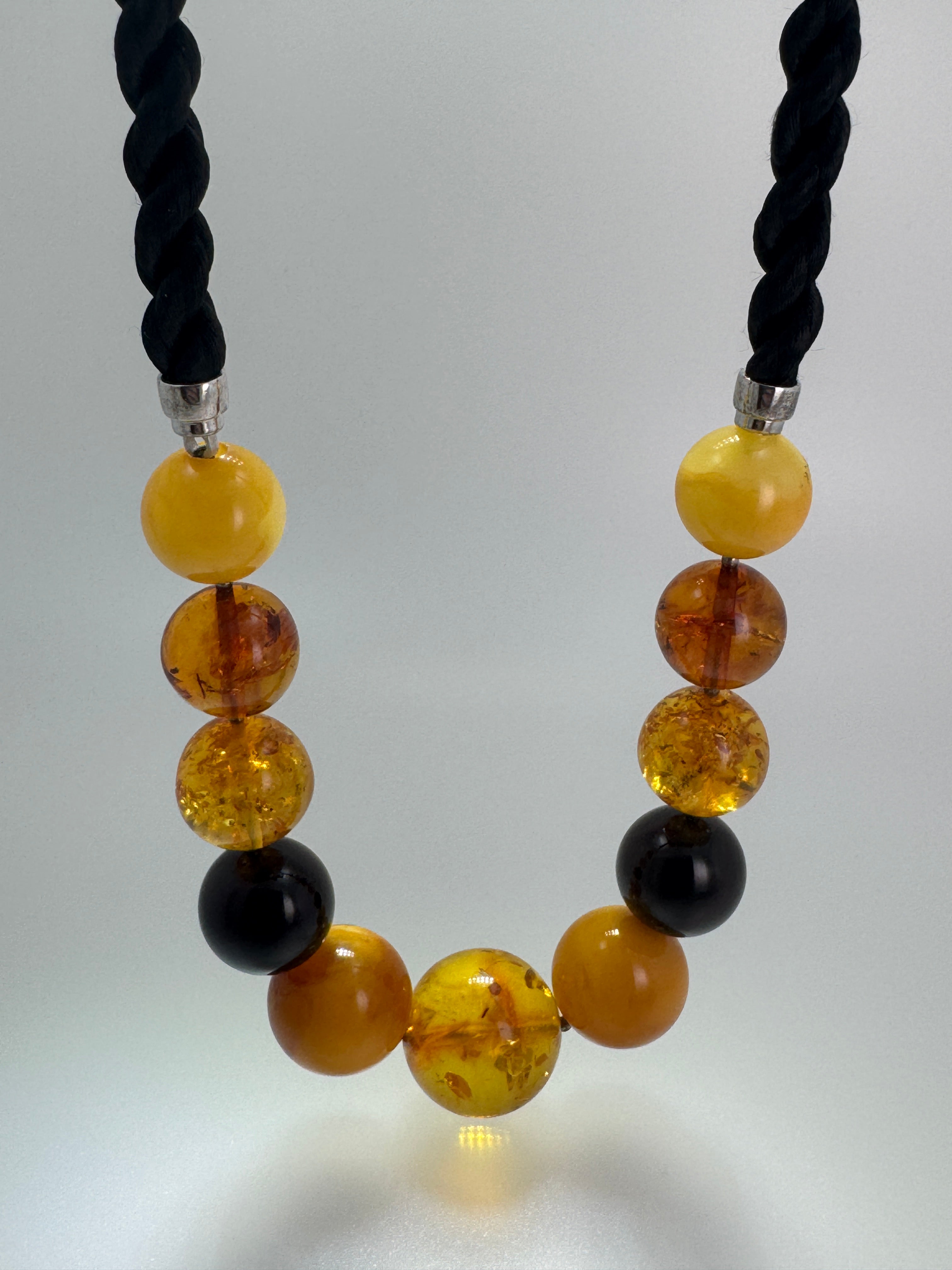 Oversized Round Baltic Amber Ball Necklace – Multicolor Graduated Design on Twisted Cord