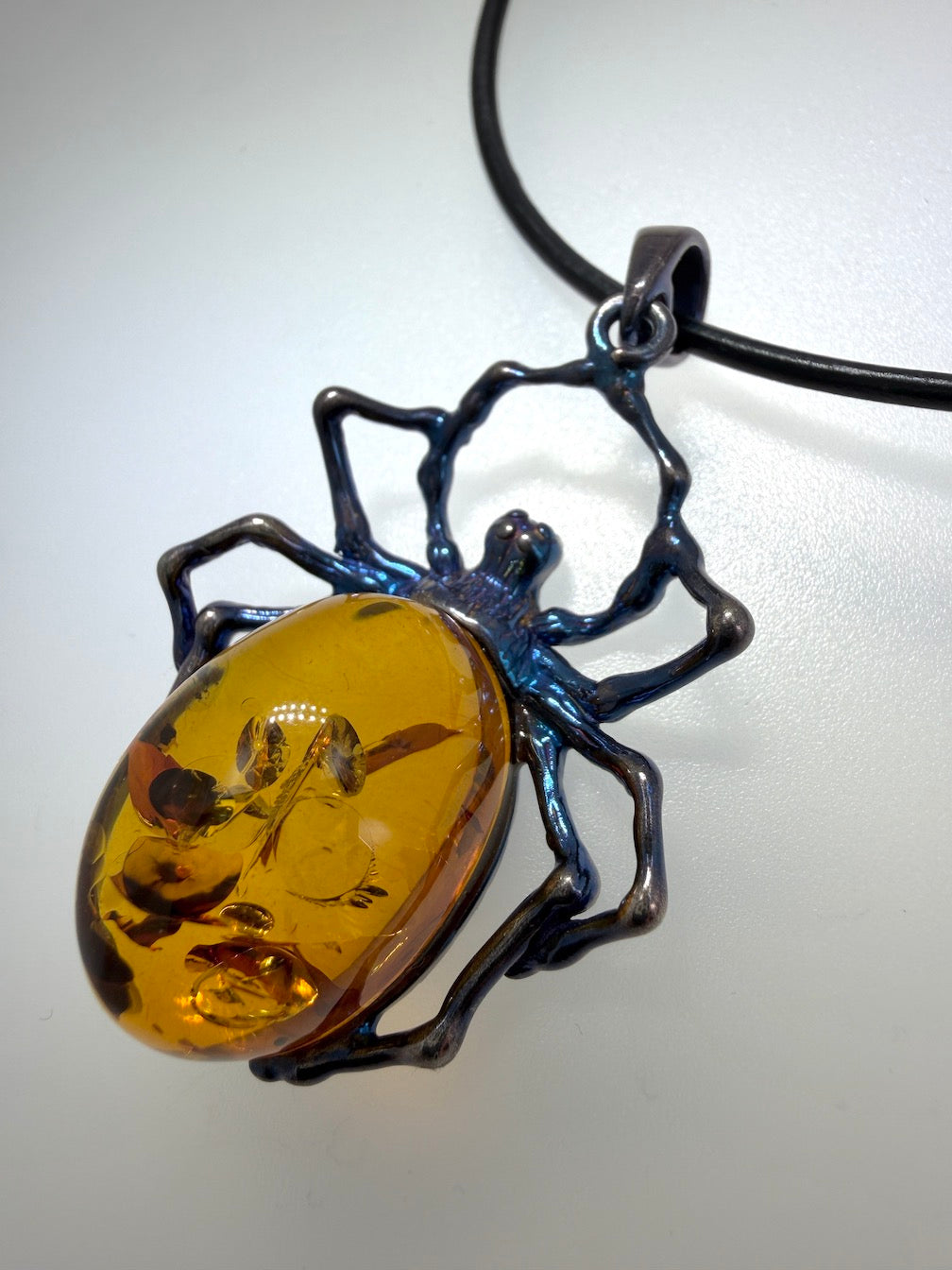 Unique Copper Blue Oxidized Sterling Silver Spider Pendant with Genuine Cognac Baltic Amber Stone on Black Leather Wire